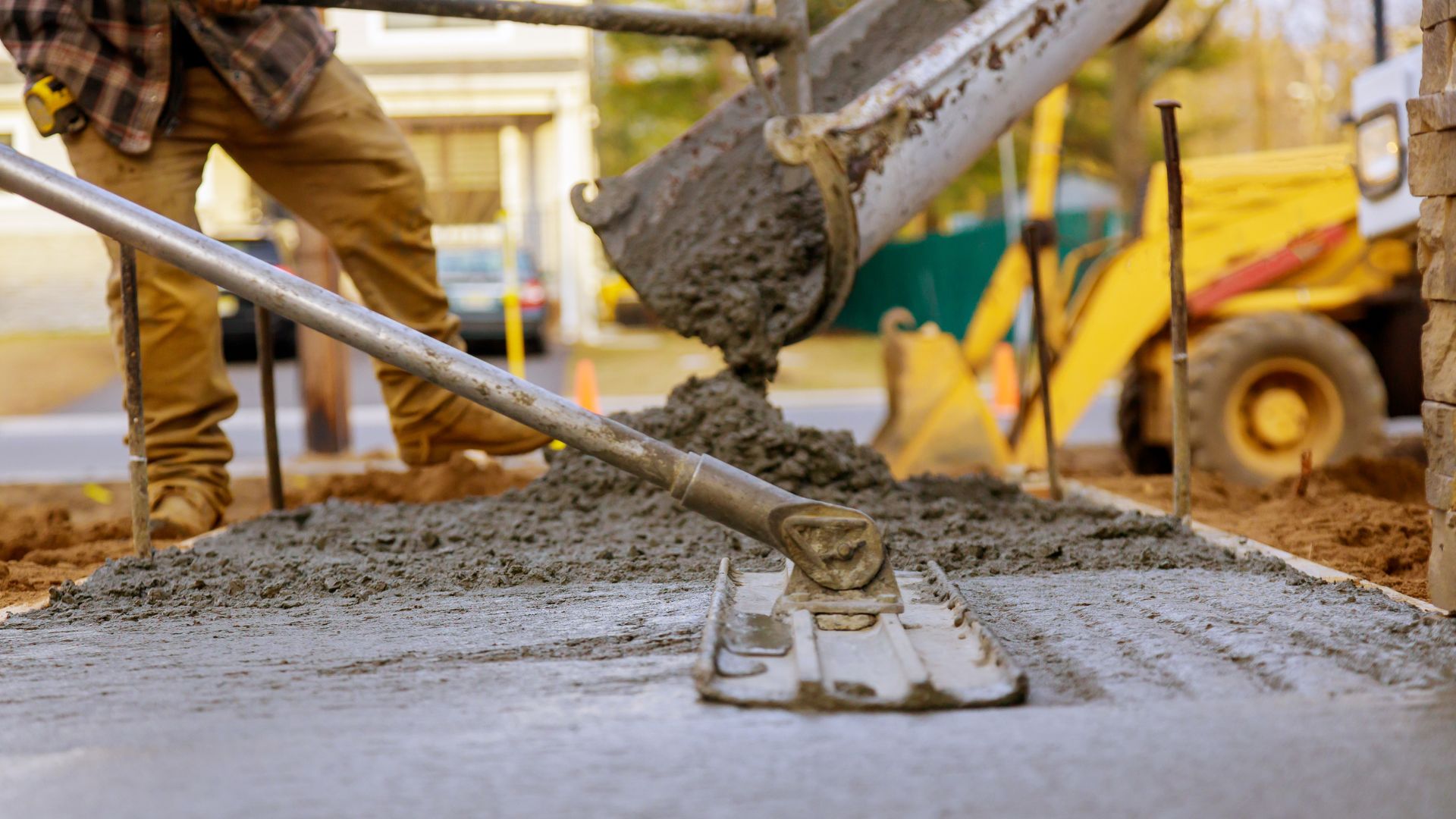 a worker doing concrete for a driveway in Woodstock, Ontario, Canada